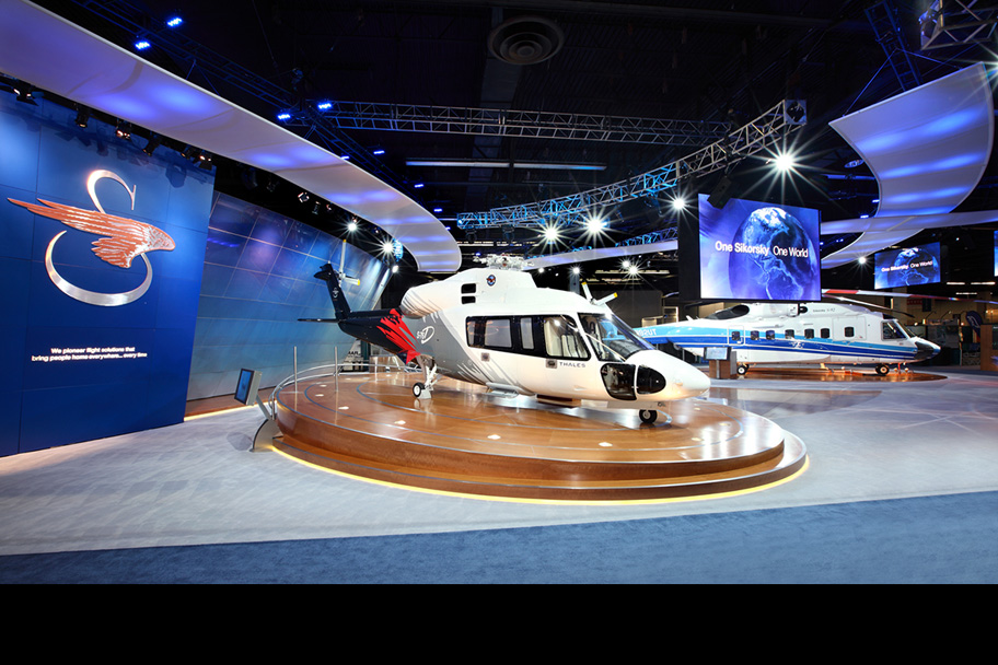The "Rolls-Royce" of executive helicopters, the S-76D is displayed on a custom stage with integrated LED lighting and A/V support. 
